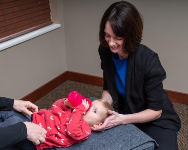A child being checked by a chiropractor